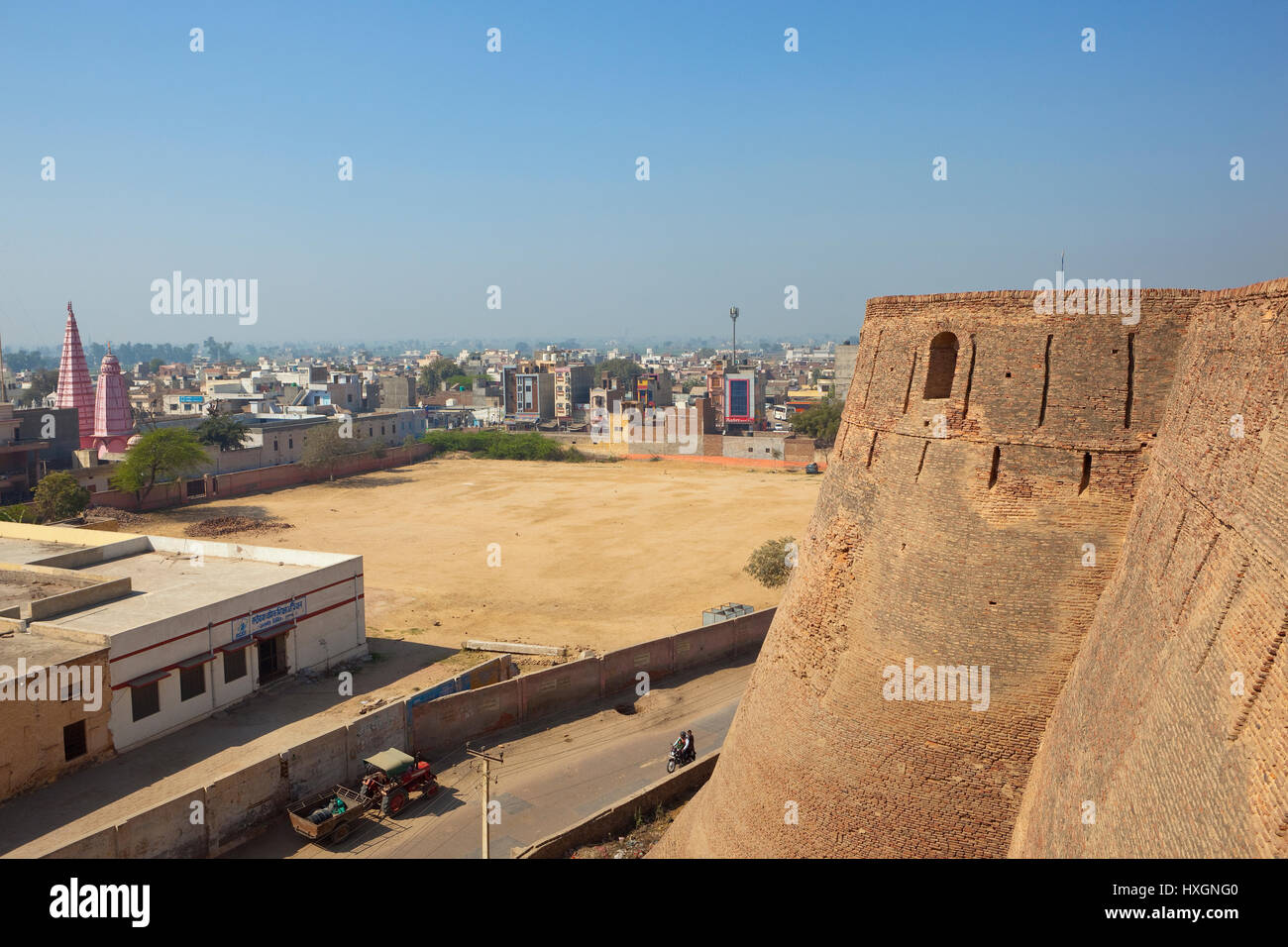 a view of hanumangarh city in rajasthan india with hindu temple and the side of bhatner fort walls under a blue sky Stock Photo