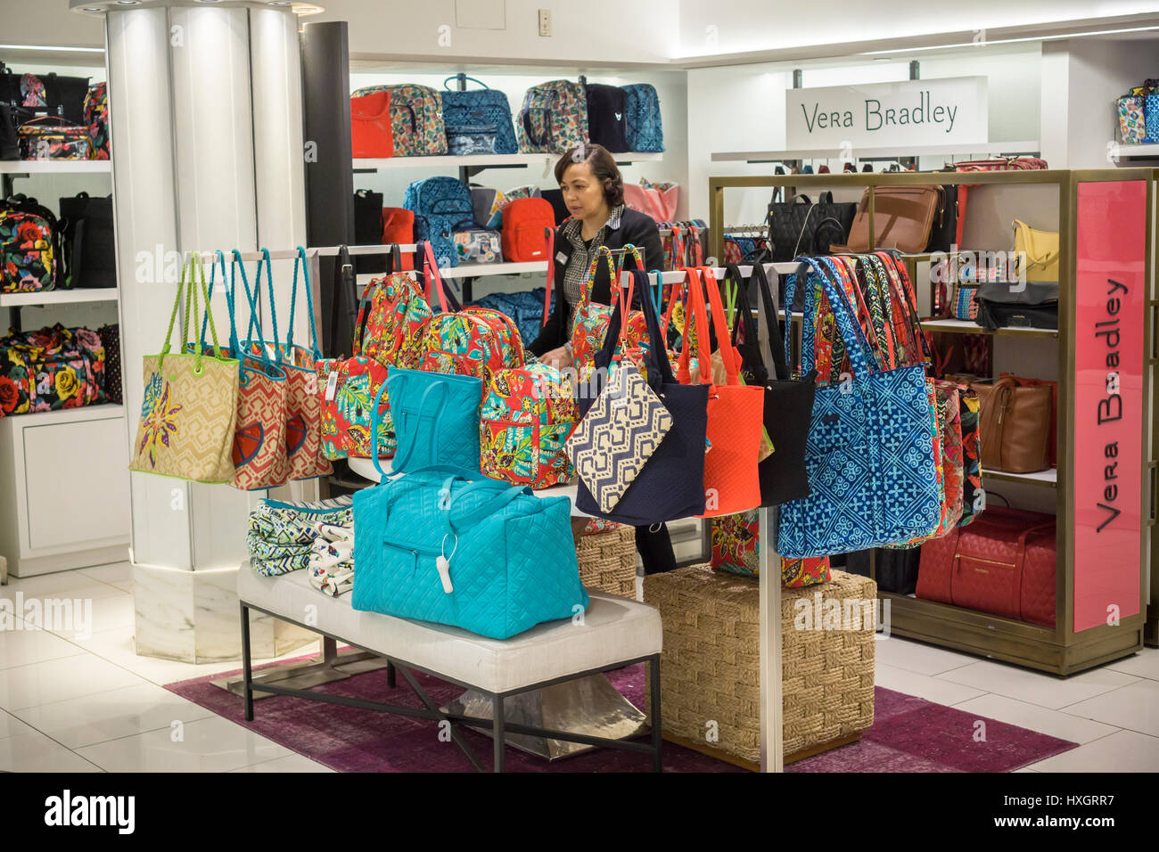 A sales associates adjusts the Vera Bradley selection of handbags in the Macy's Herald Square flagship store on Sunday, March 26, 2017. (© Richard B. Levine) Stock Photo