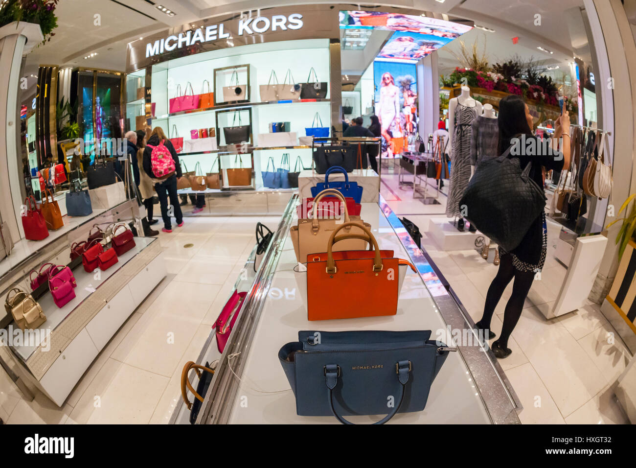 Shoppers browse Michael Kors handbags in the Macy's Herald Square flagship  store on Sunday, March 26, 2017. (© Richard B. Levine Stock Photo - Alamy