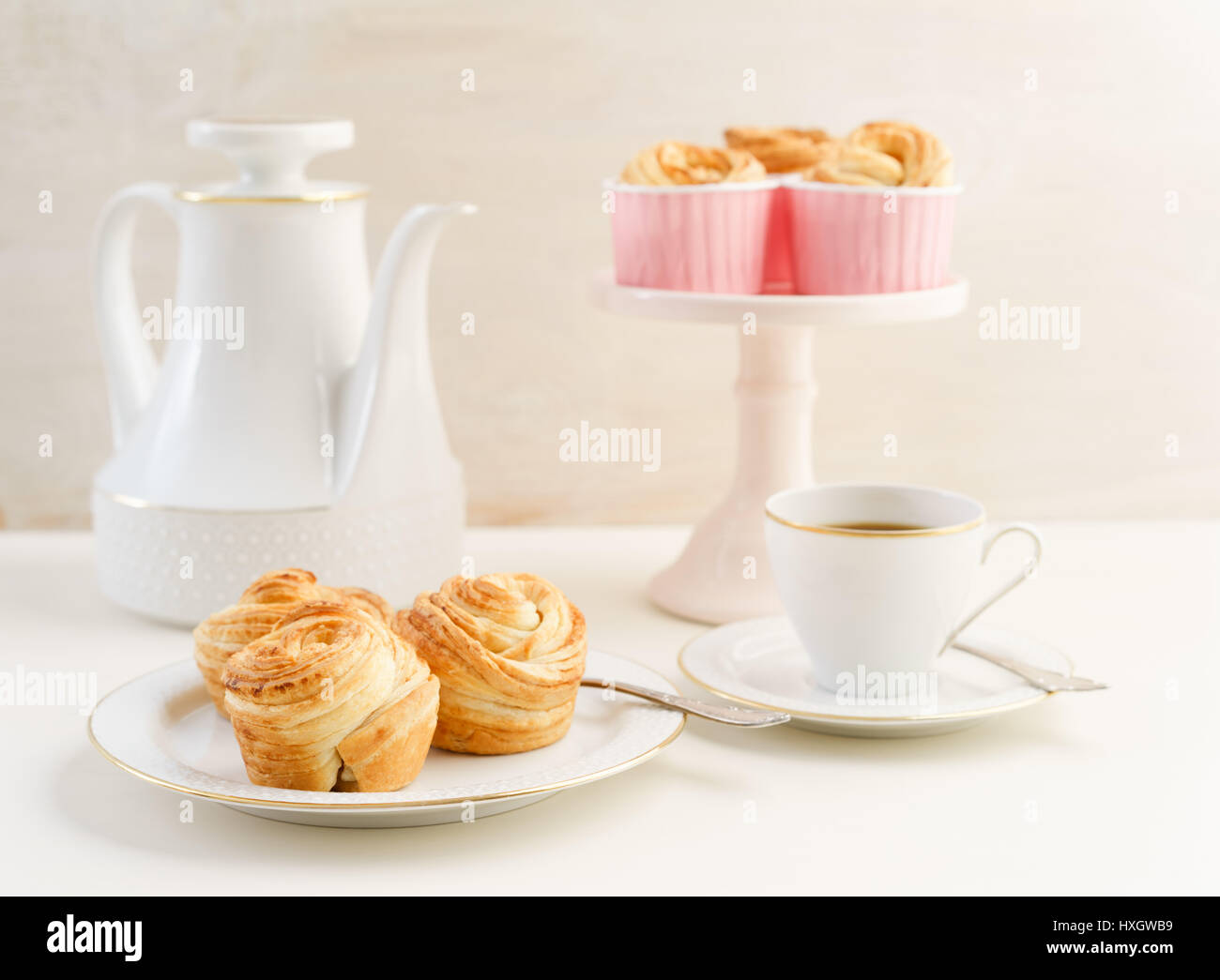 Coffee table with fresh baked cruffins trend pastry Stock Photo