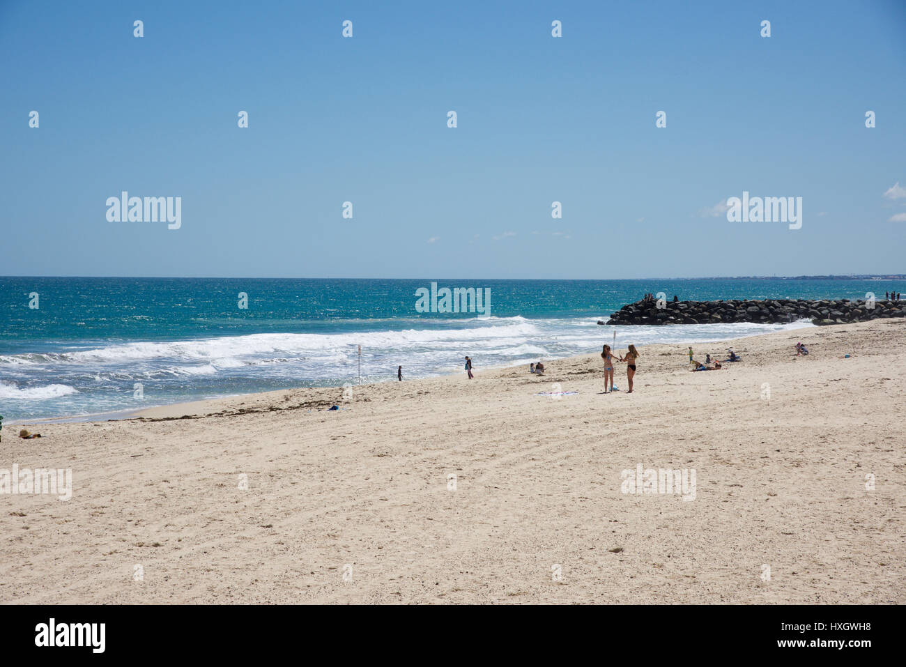 City Beach,WA,AustraliaOctober 5,2016Indian Ocean waves, rocky groyne and tourists at City