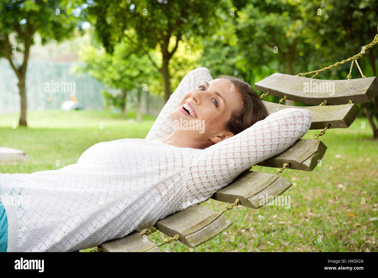 Portrait of a smiling older woman relaxing on hammock outdoors Stock ...