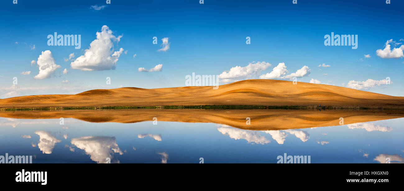 Idyllic scene of spring clear blue sky and white clouds. Reflection in ...