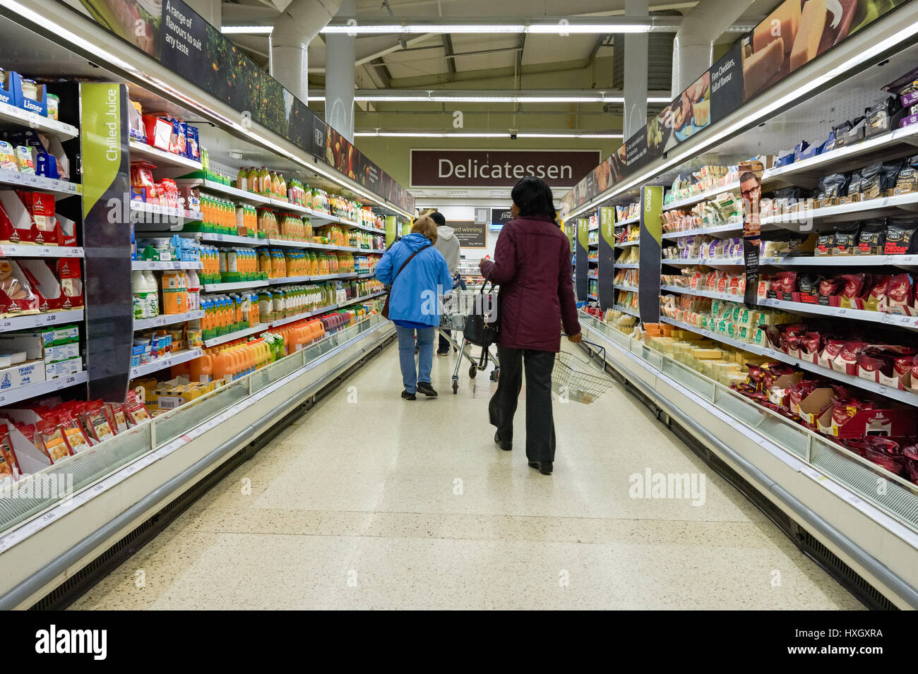 Shoppers at the aisle at Tesco supermarket food hall, UK Stock Photo