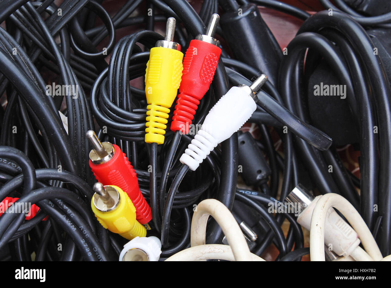Cable texture. Cables background. Audio video rca jack power cord and black cables on white background. Stock Photo
