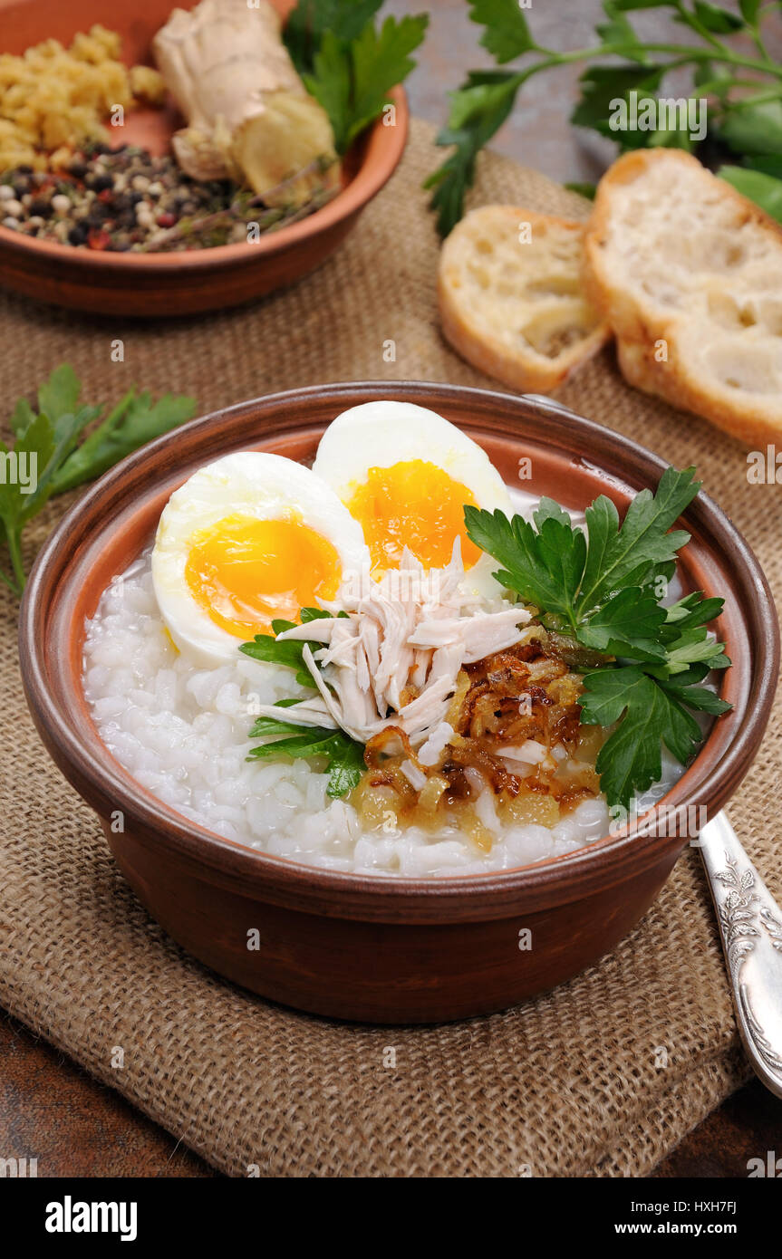 Rice porridge ginger congee with egg, chicken, crispy shallots and