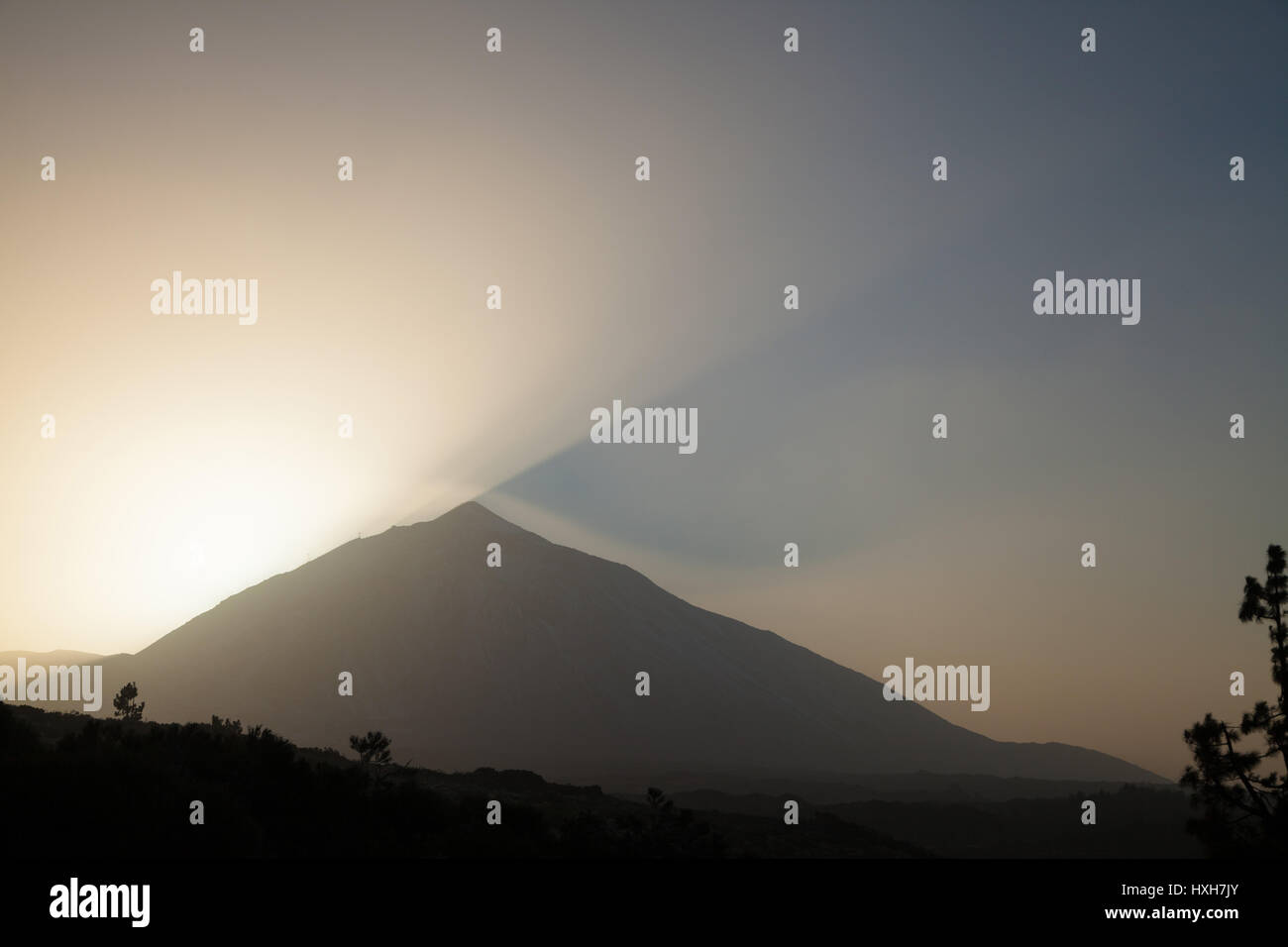 The sun setting behind the El Teide Volcano on Tenerife Stock Photo
