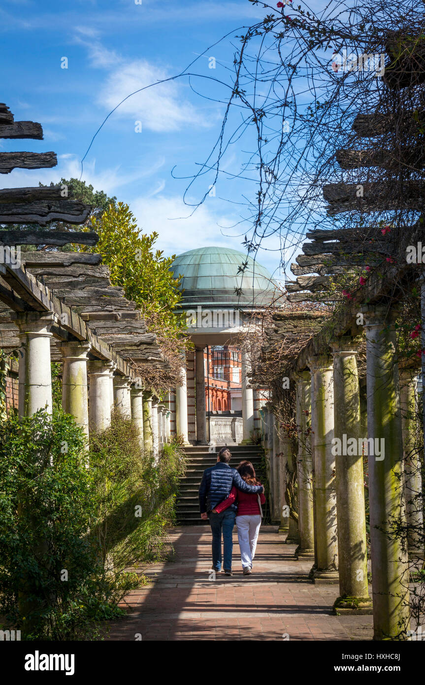 A couple walking through Hampstead Pergola & Hill Gardens on Hampstead Heath, London, UK Stock Photo