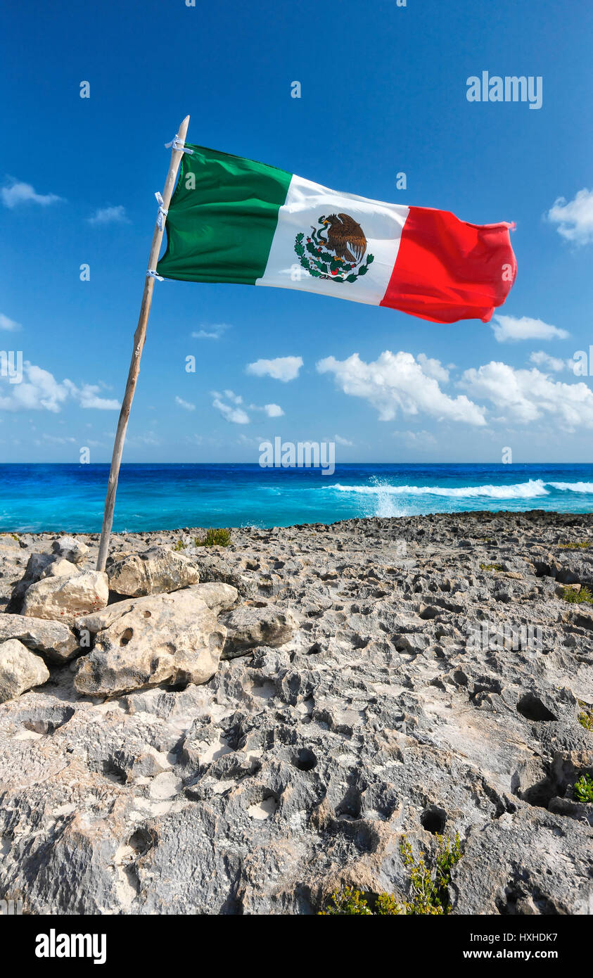 Mexican flag on rocky beach on island Cozumel Stock Photo