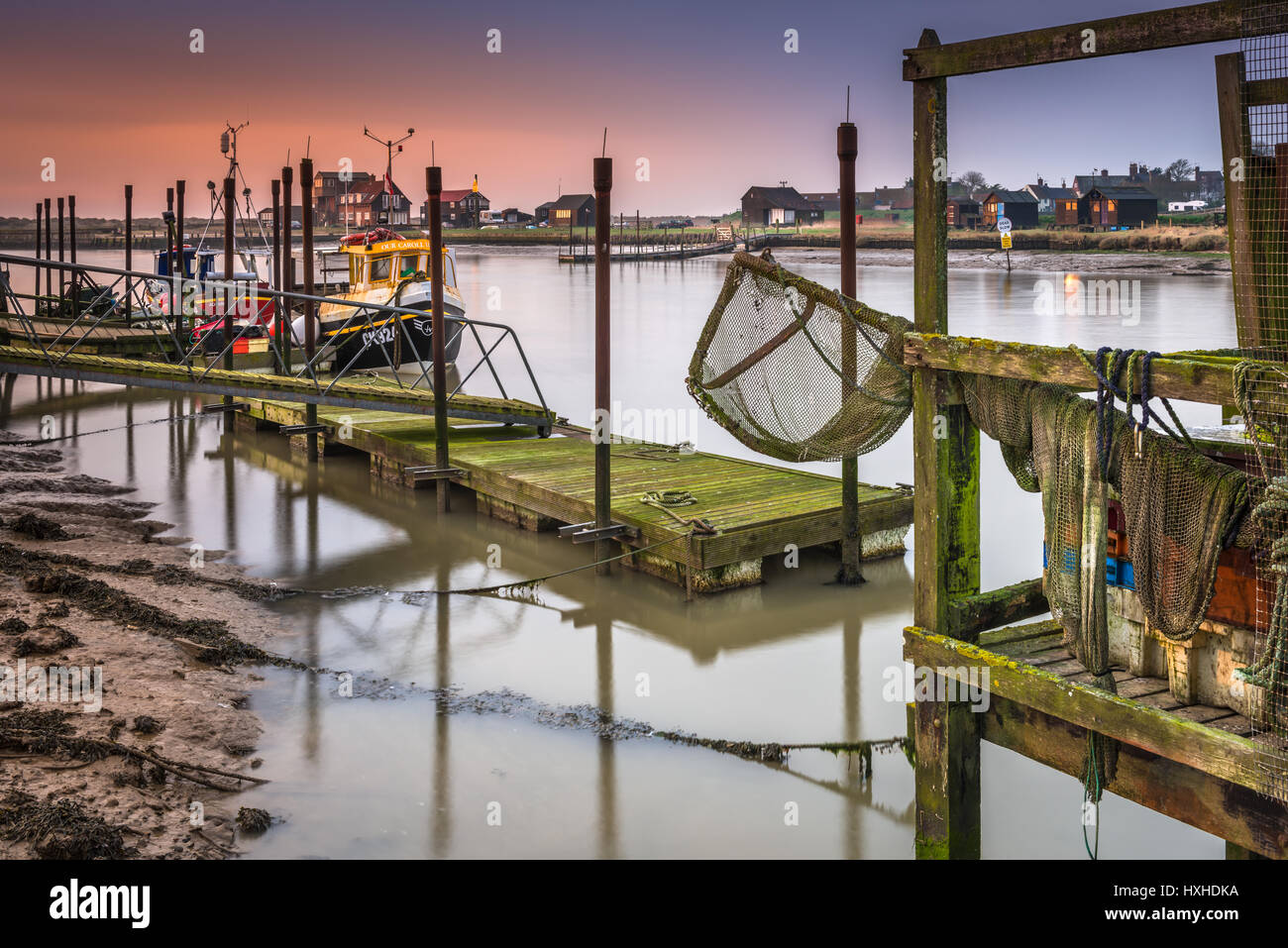 Fishing nets hang over the pontoons on Blackshore in Southwold, Suffolk, at dawn in mid March. Stock Photo