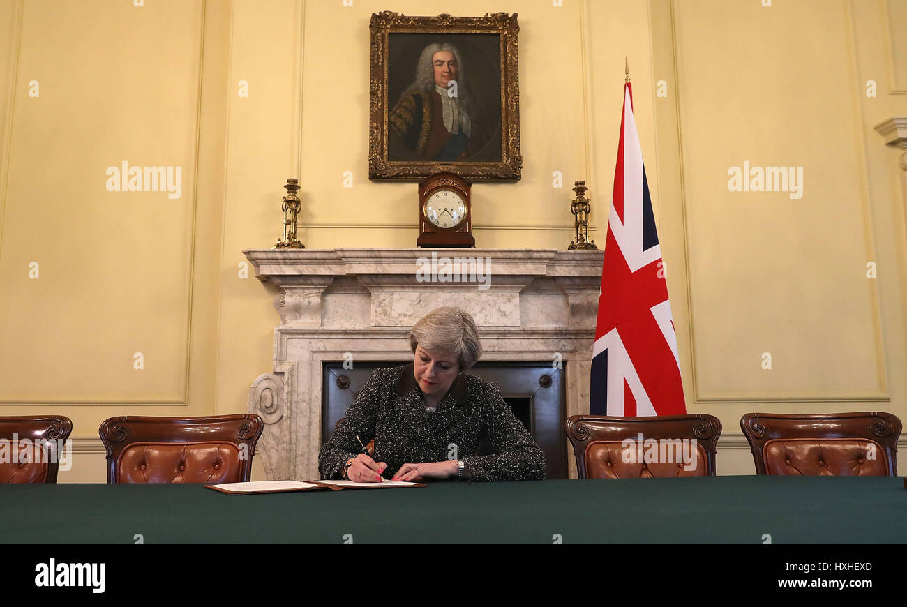 Prime Minister Theresa May in the cabinet signs the Article 50 letter, as she prepares to trigger the start of the UK's formal withdrawal from the EU on Wednesday. Stock Photo