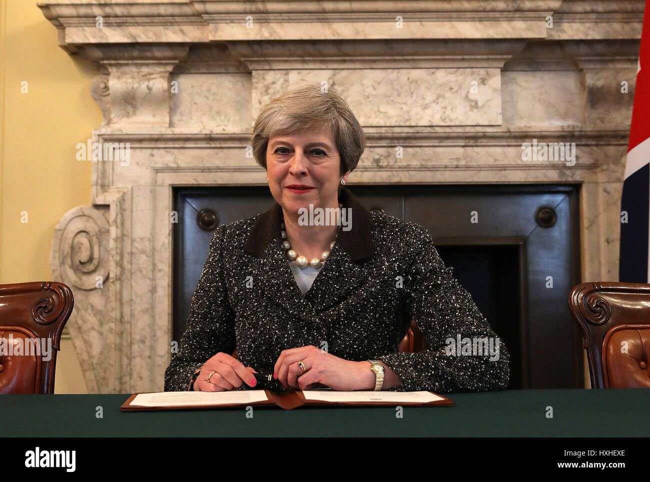 Prime Minister Theresa May in the cabinet signs the Article 50 letter, as she prepares to trigger the start of the UK's formal withdrawal from the EU on Wednesday. Stock Photo