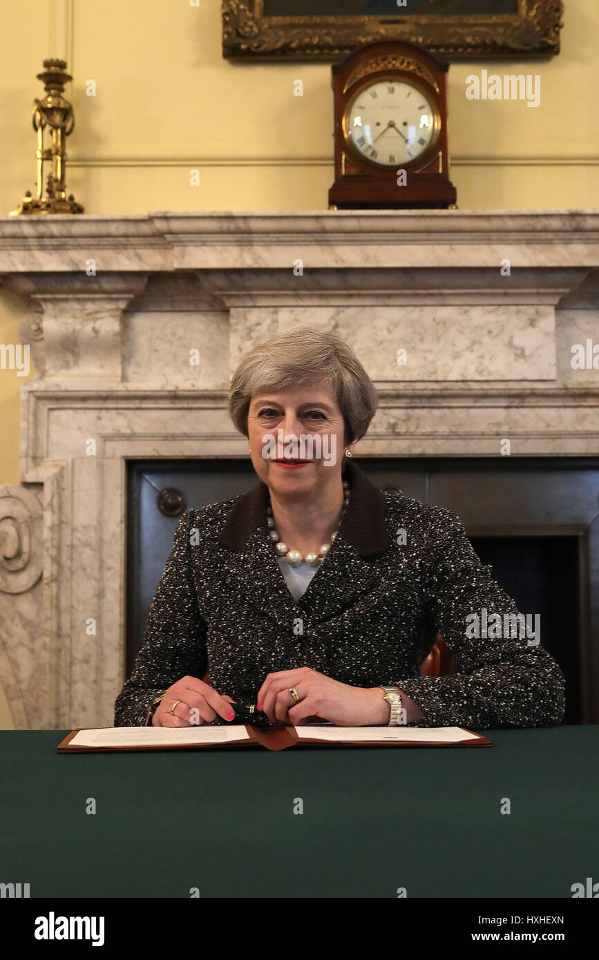 Embargoed to 2200 Tuesday March 28 Prime Minister Theresa May in the cabinet signs the Article 50 letter, as she prepares to trigger the start of the UK's formal withdrawal from the EU on Wednesday. Stock Photo