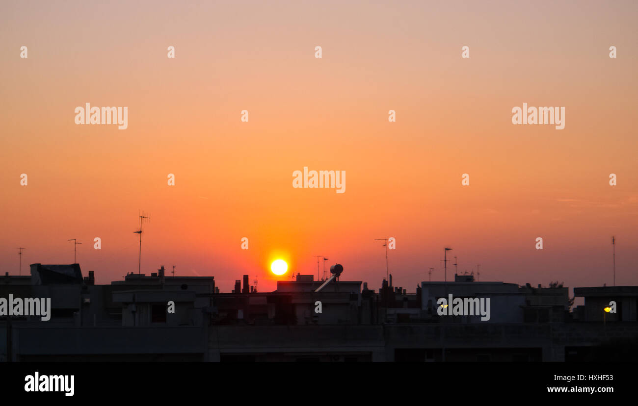 Silhouette of mediterranean village to sunset . Stock Photo