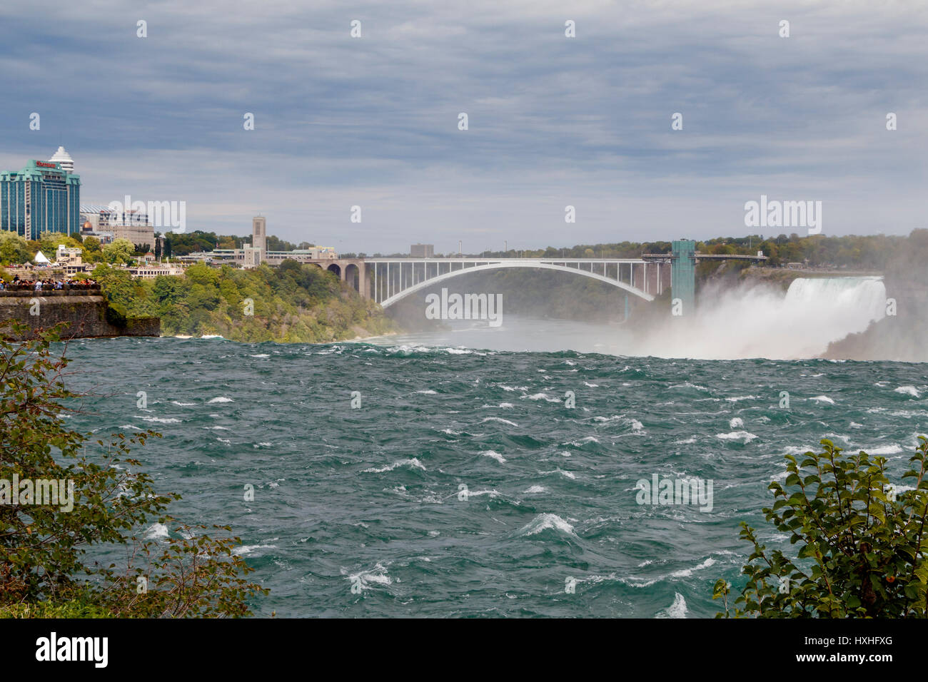 The Niagara River and American Falls with the Rainbow Bridge crossing point on the border between New York State, USA, and Ontario, Canada. Stock Photo