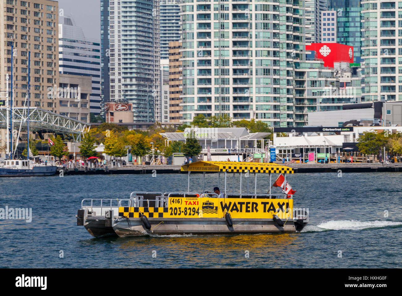 A Water Taxi on the shoreline of Lake Ontario with the buildings of