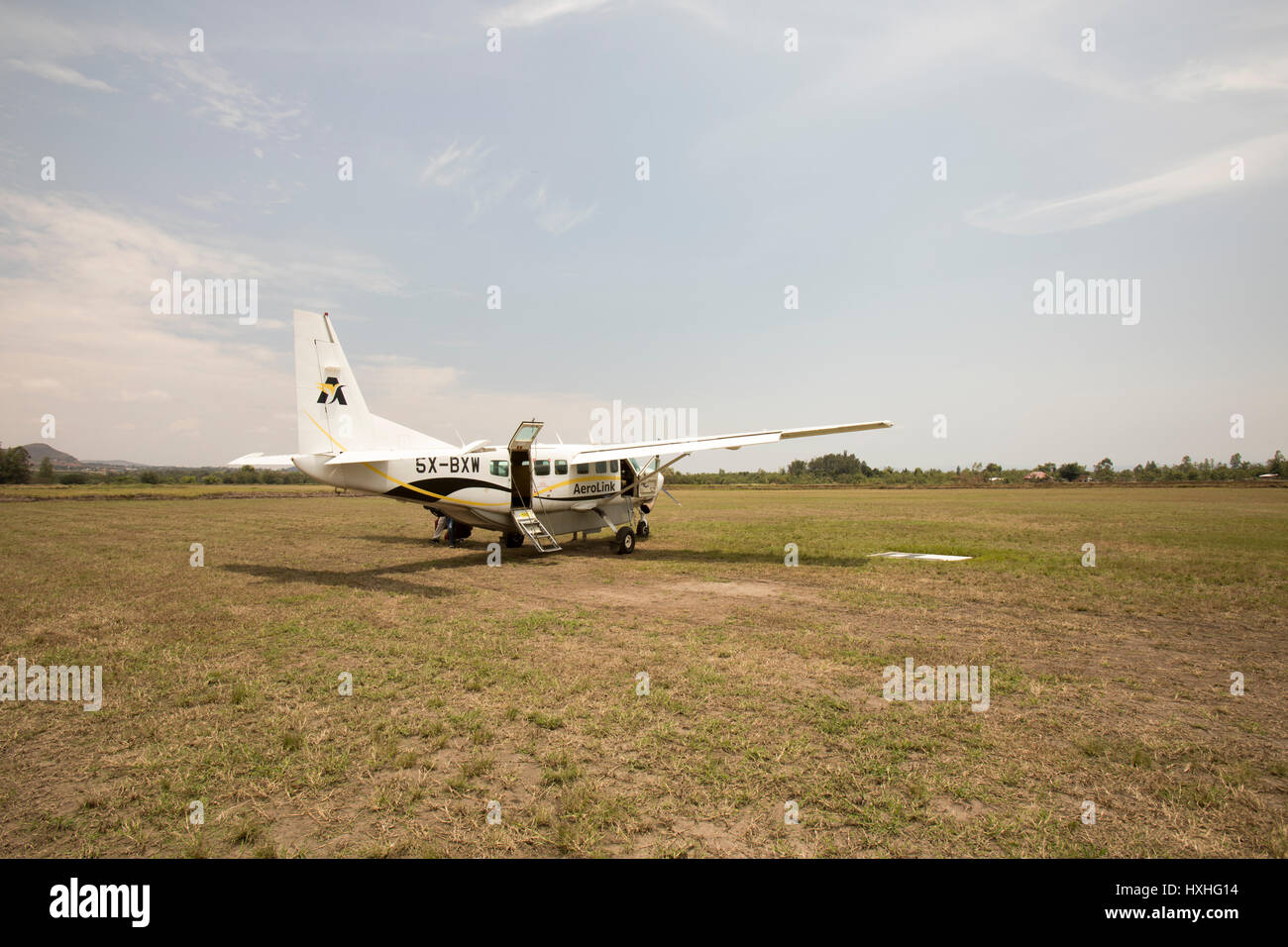 Kesese, Uganda - February 22, 2017 : AeroLink plane on dirt runway of Kesese, Uganda. Stock Photo