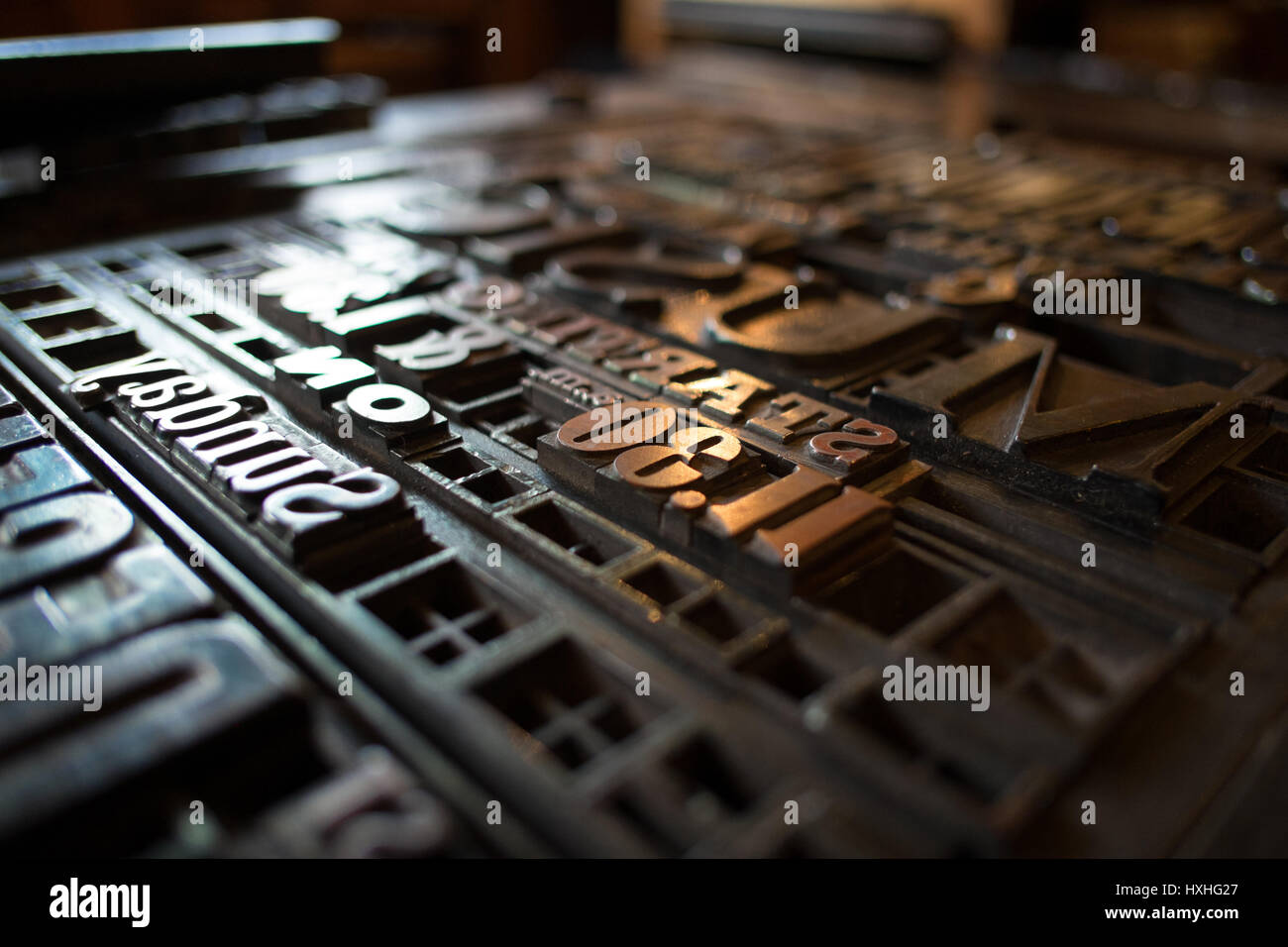 typeset letters and numbers are laid out on a vintage printing press Stock Photo