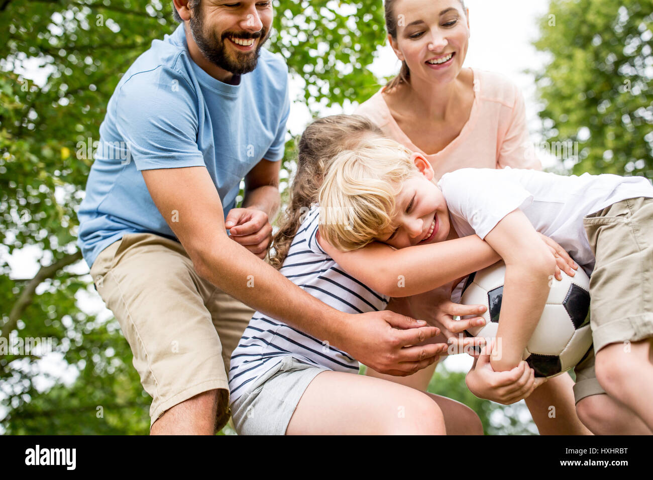 Family with soccer ball argue ober the football Stock Photo