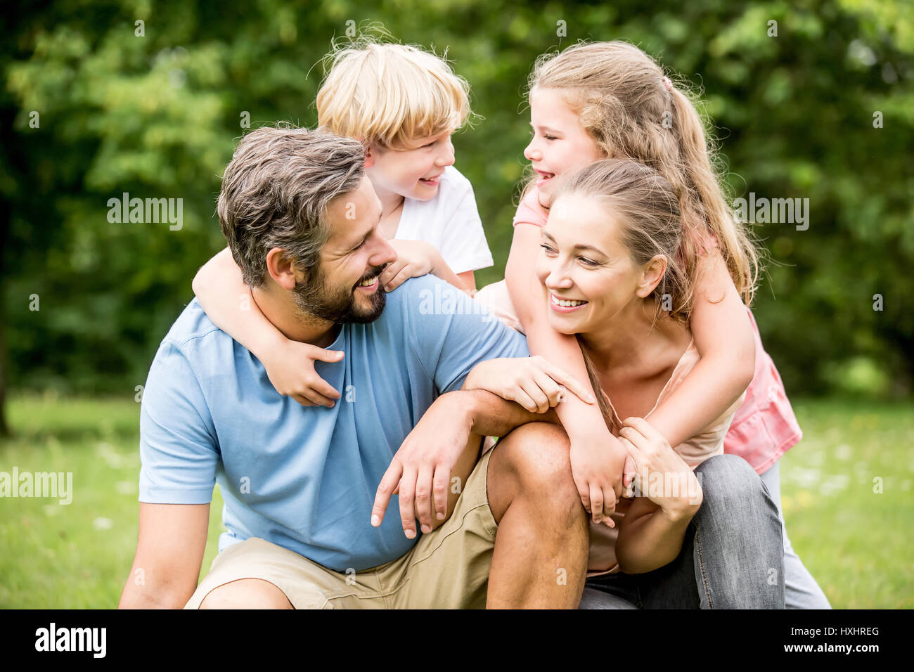 Children and parents as happy family together in a big hug Stock Photo