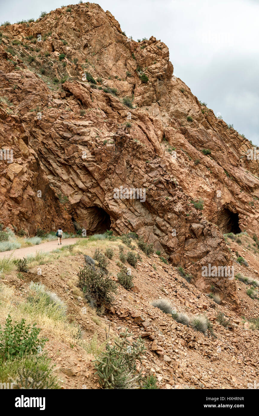 Woman hiker and rock tunnels, Tunnel Drive Trail, Canon City, Colorado Stock Photo