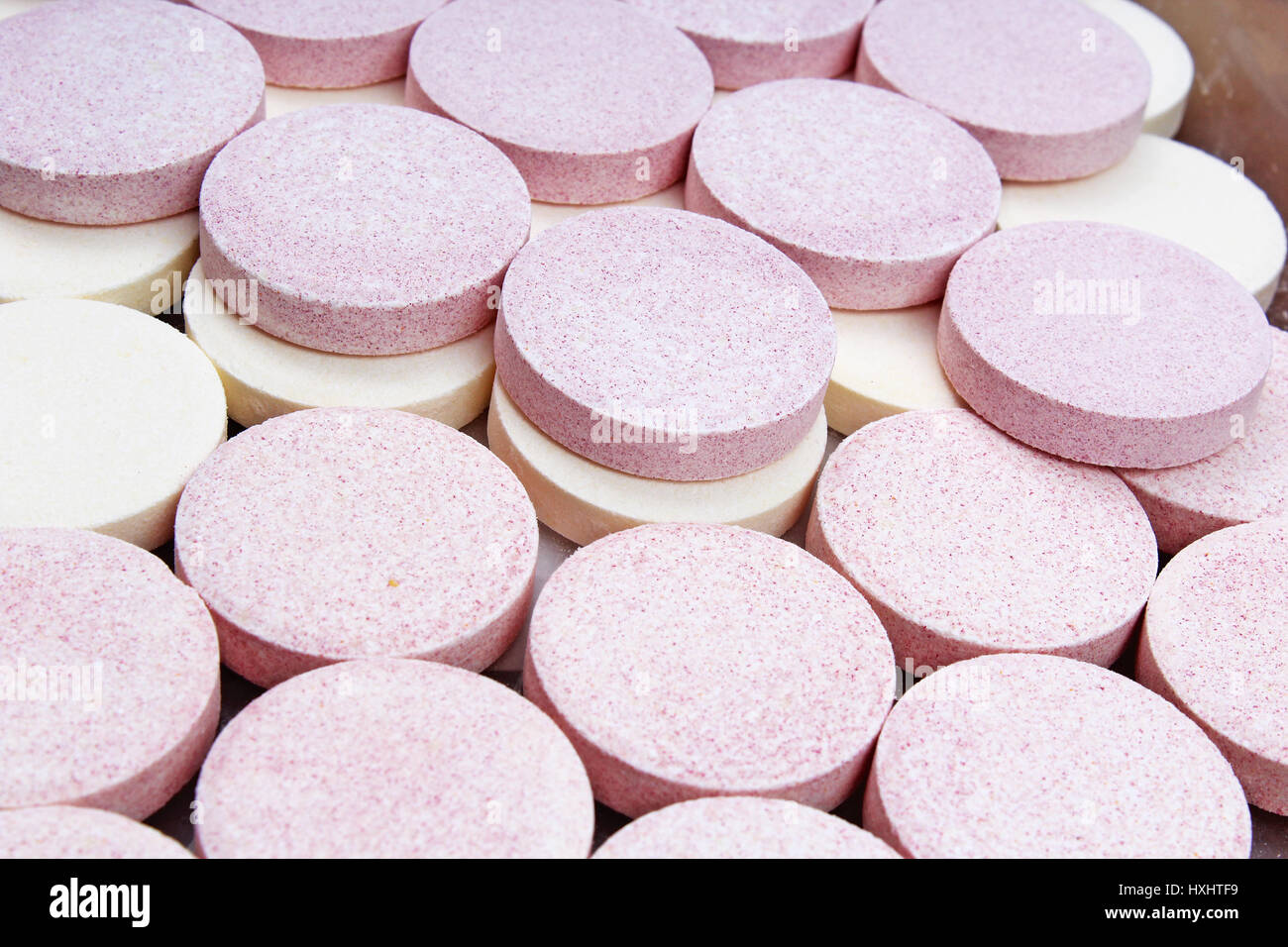 Stack of vitamin mineral supplement effervescent tablets pattern texture. Multivitamin supplement tablet. Soluble Vitamin. Fizzy tablet. Orange flavor Stock Photo