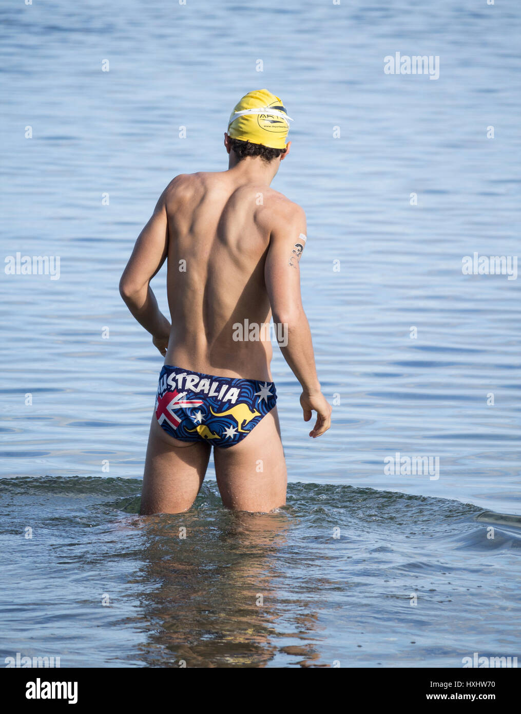 Athletic man wearing Australia swimming trunks. Stock Photo
