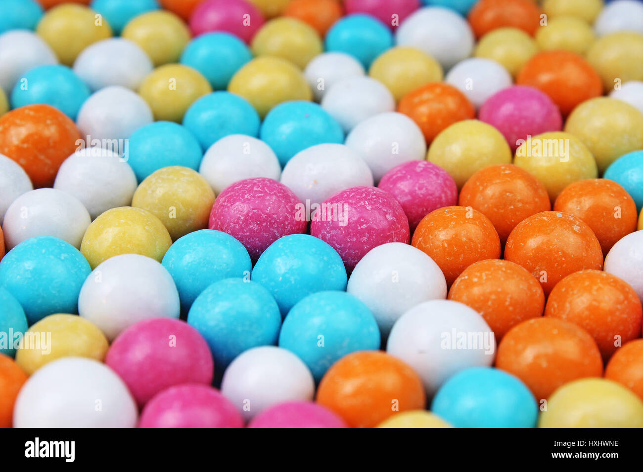 Bubble gum chewing gum texture. Rainbow multicolored gumballs chewing gums as background. Round sugar coated candy dragee bubblegum texture Stock Photo