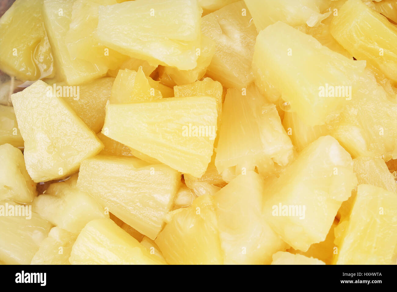 Pineapple slices as background. Yellow pineapples texture pattern. Stock Photo