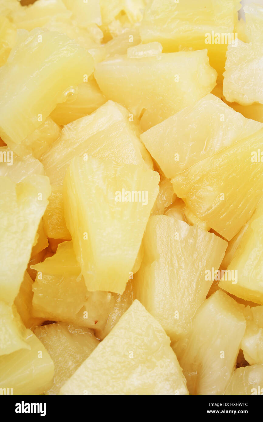 Pineapple slices as background. Yellow pineapples texture pattern. Stock Photo