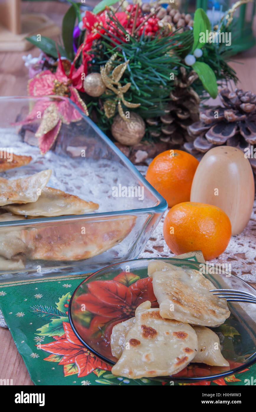 Dumplings with cabbage and mushrooms -  traditional Polish Christmas Eve dishes on the table Stock Photo