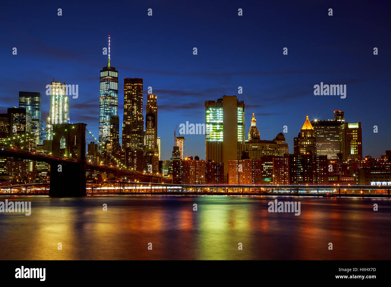 New York City's Brooklyn Bridge and Manhattan skyline illuminated at ...