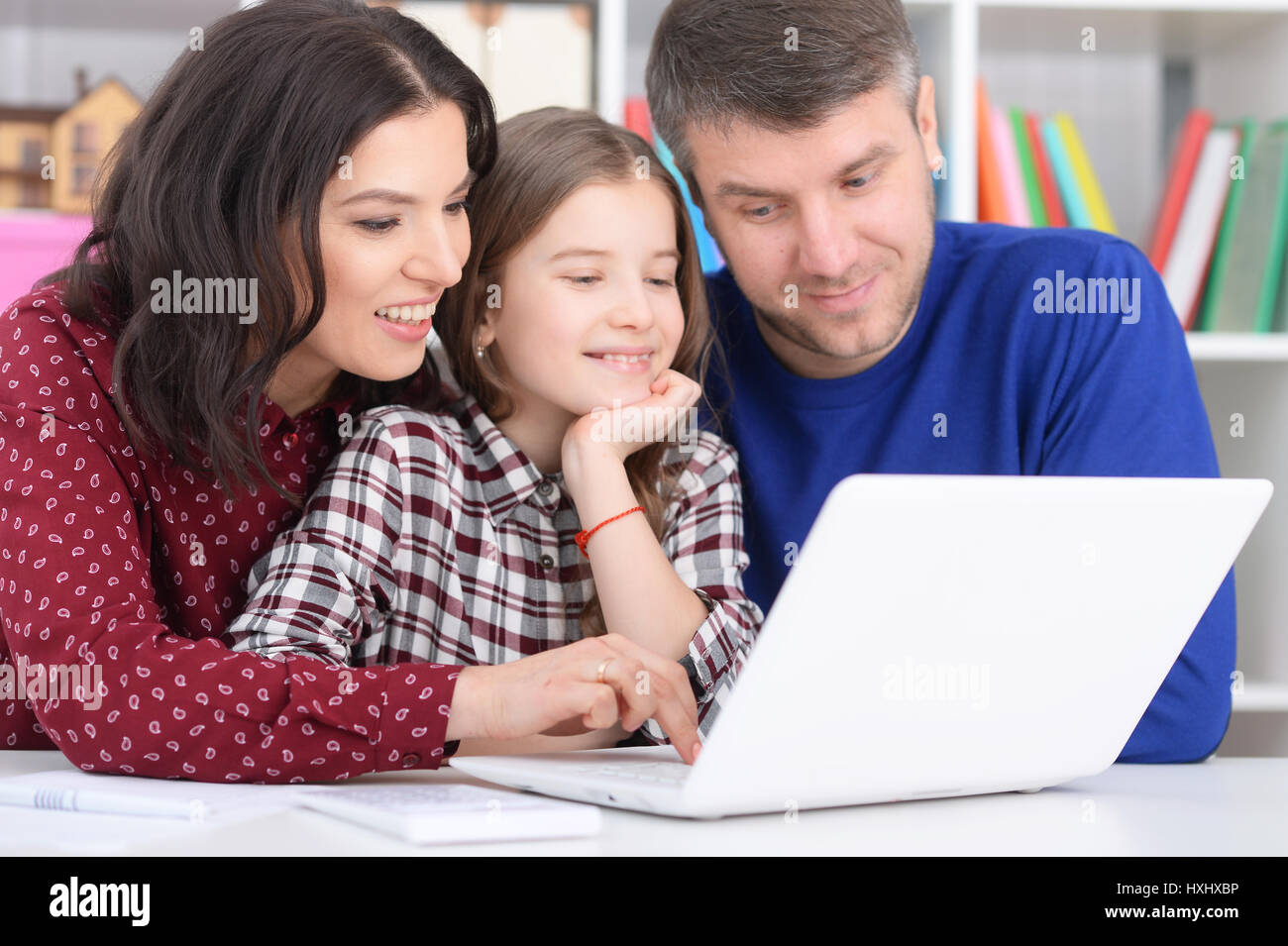 Family with a daughter using a laptop Stock Photo