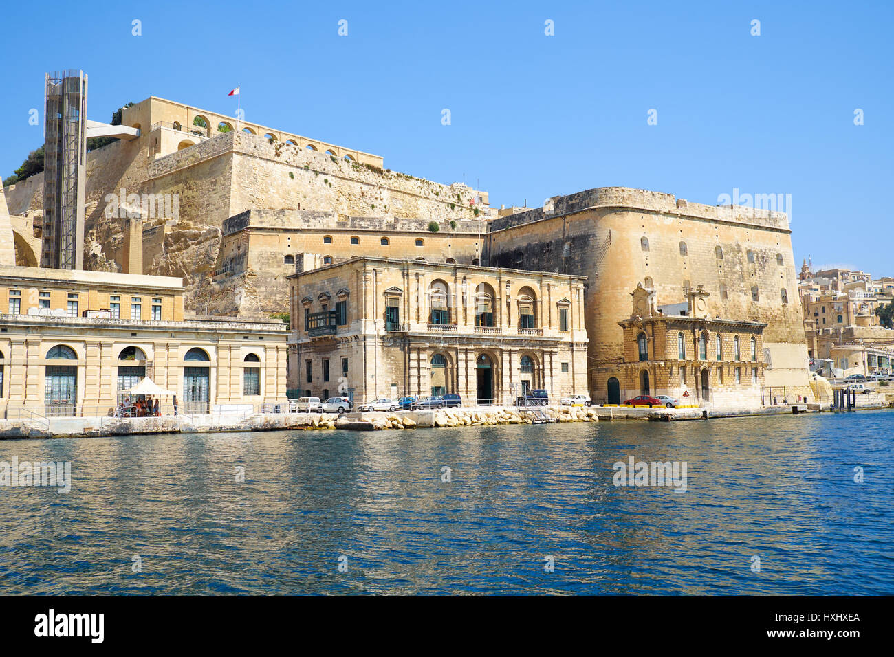 VALLETTA, MALTA - JULY 23, 2015: The view of Valletta fortifications with Fort Lascaris and Upper and Lower Barrakka Gardens  from the water of Grand  Stock Photo