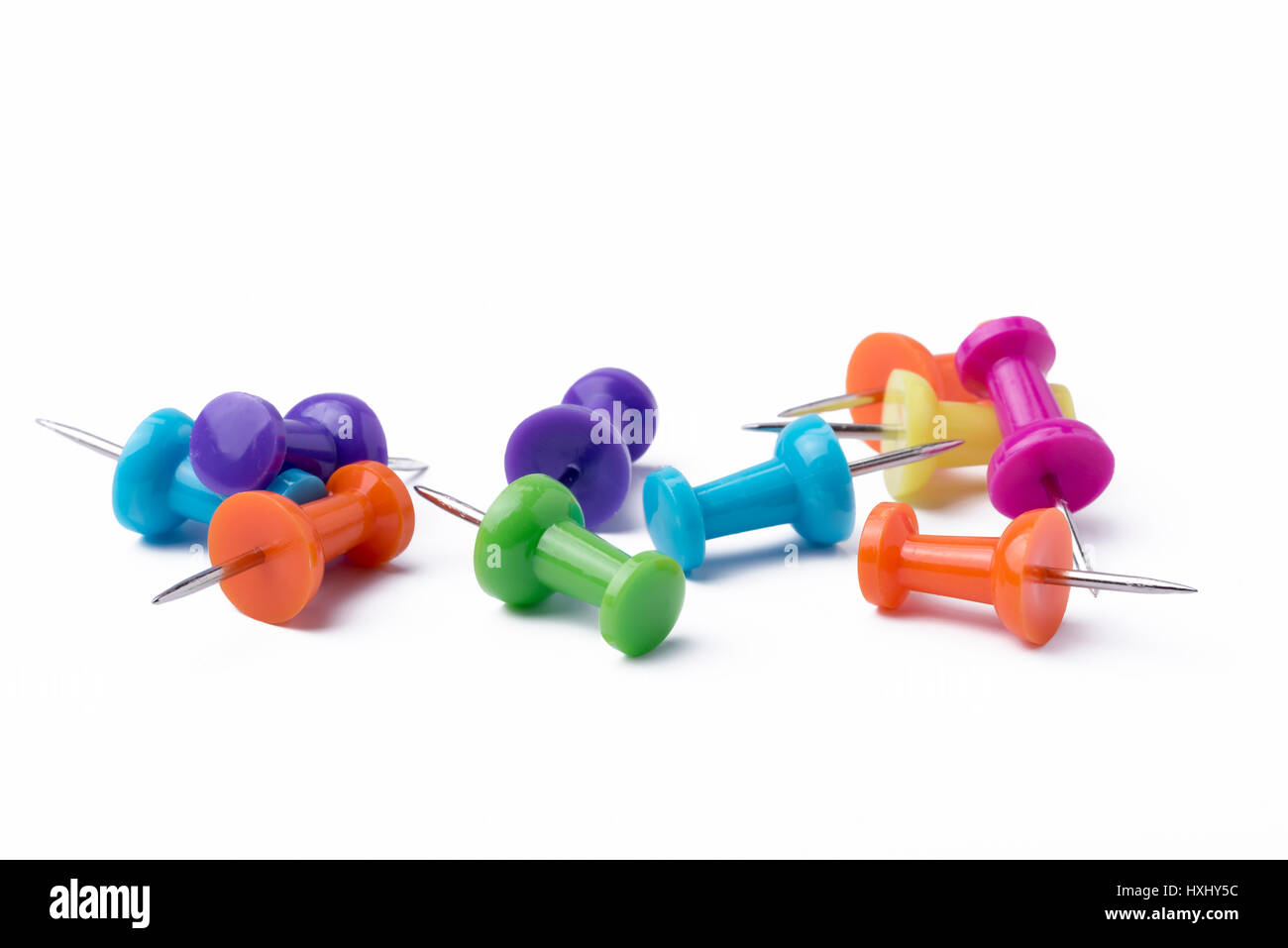 Multicolored pushpins on a white background. Stock Photo