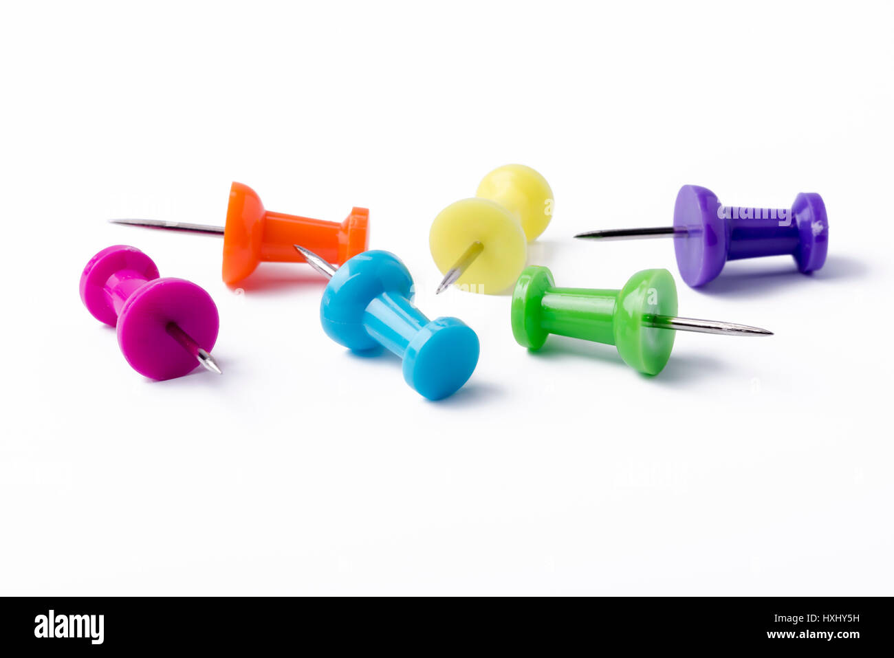 Multicolored pushpins on a white background. Stock Photo