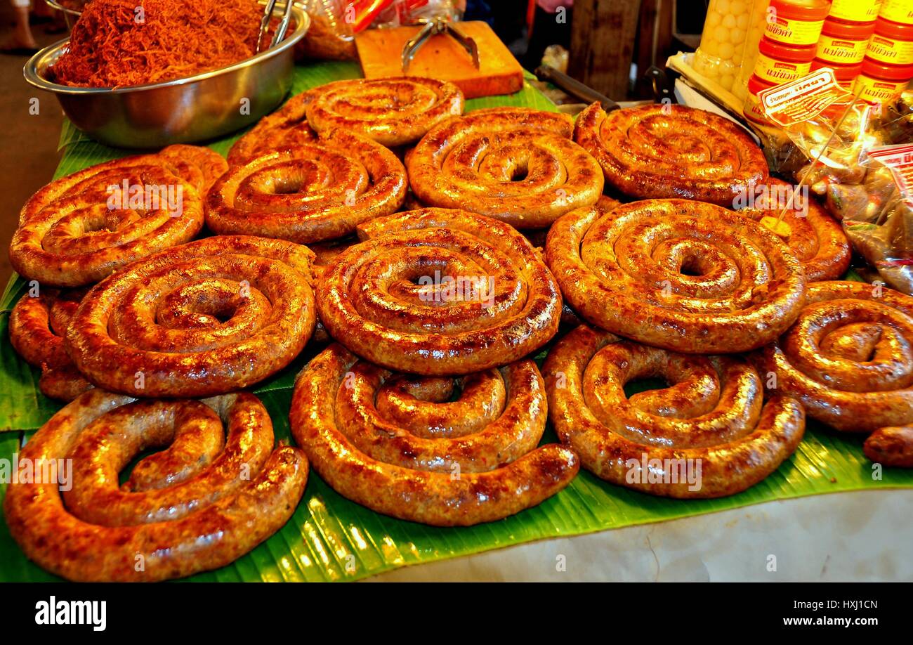 Lampang, Thailand - December 28, 2012:  Coils of pork and rice sausages at a food stand in the Kad Tung Kwian Market  * Stock Photo