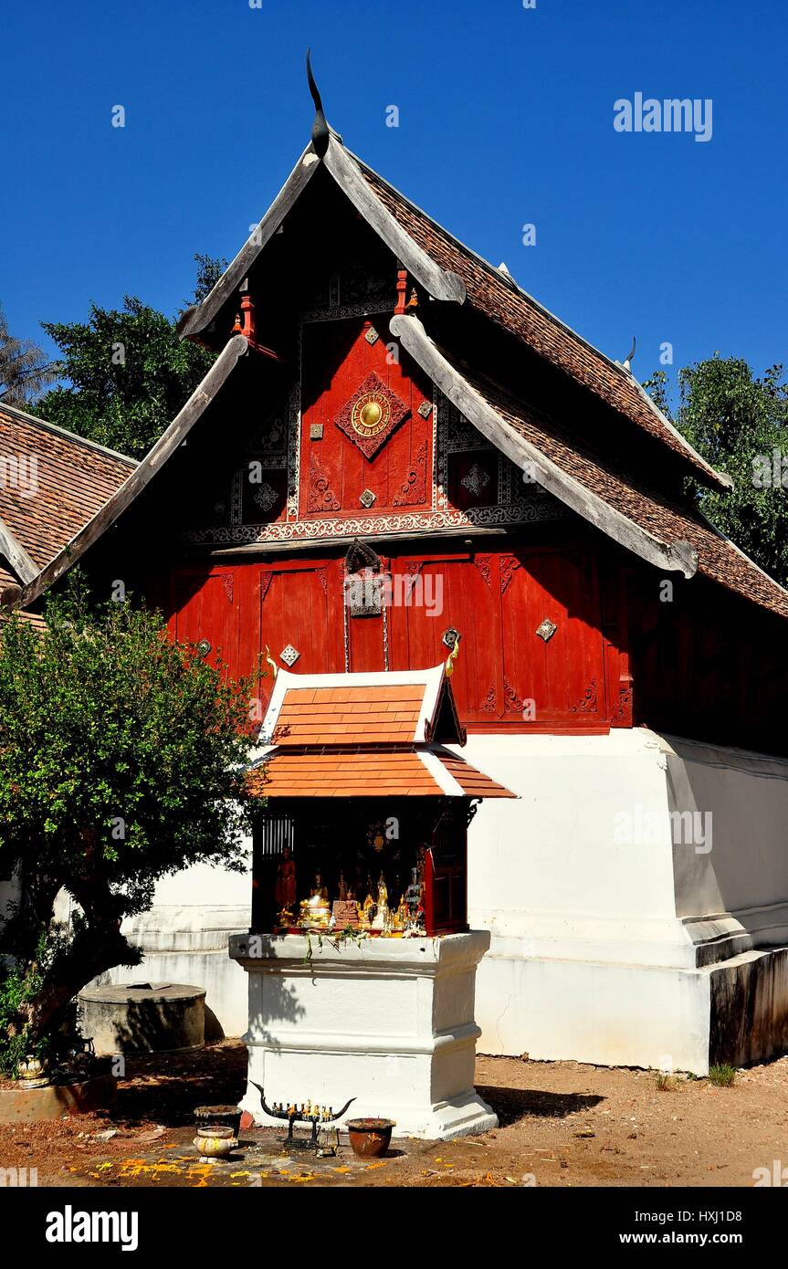 Lampang, Thailand - December 28, 2012:  The wooden Repository Library with unique sloping roofs and wooden facade panels at Wat Phra That Lampang Luan Stock Photo