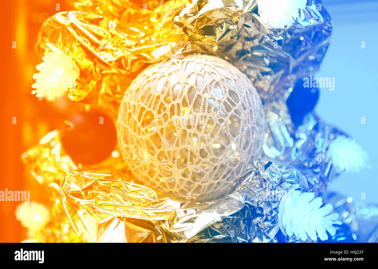 Beautiful gold Christmas tree with white balls photographed in closeup