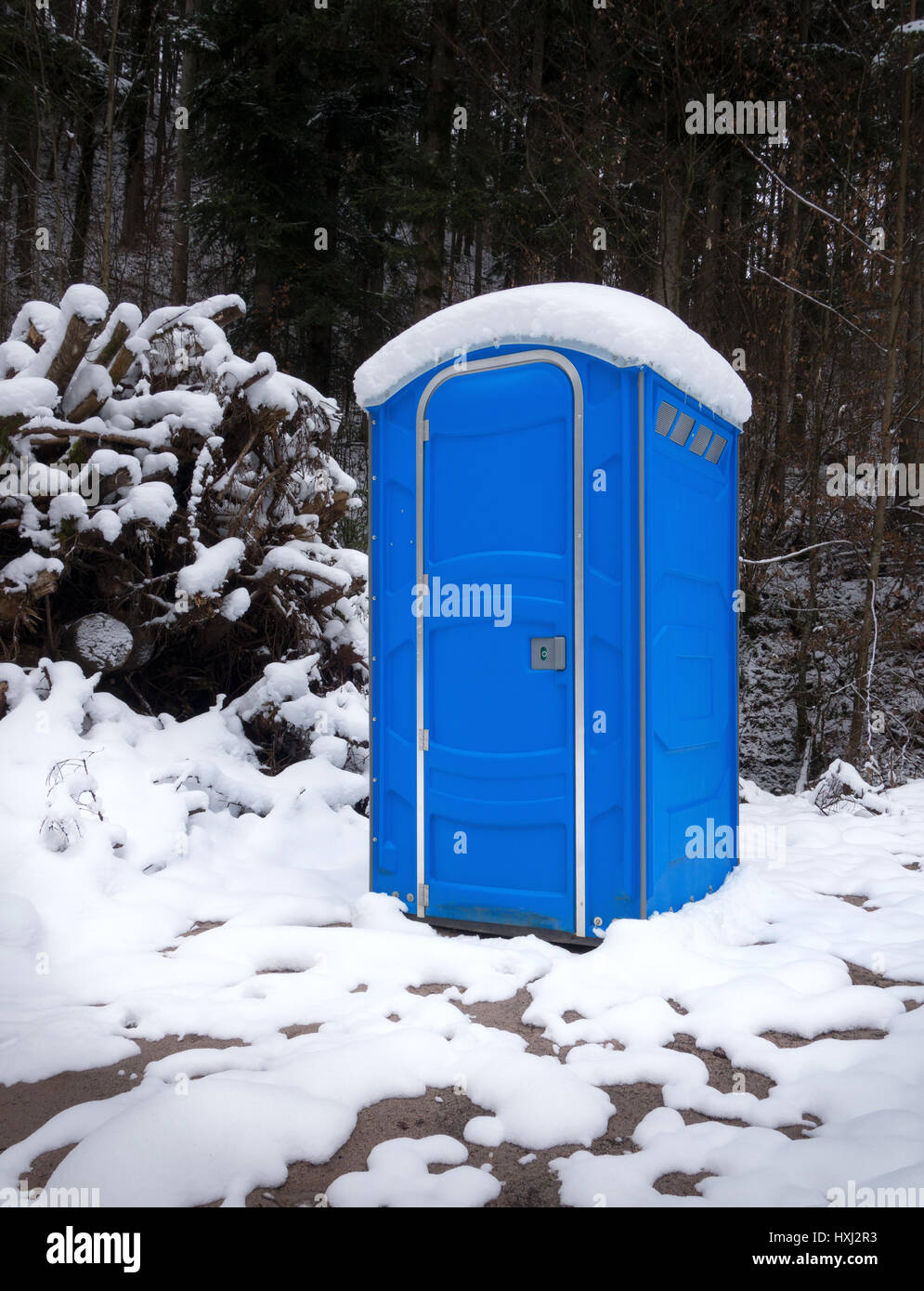 Snowy portable toilet in the forest Stock Photo