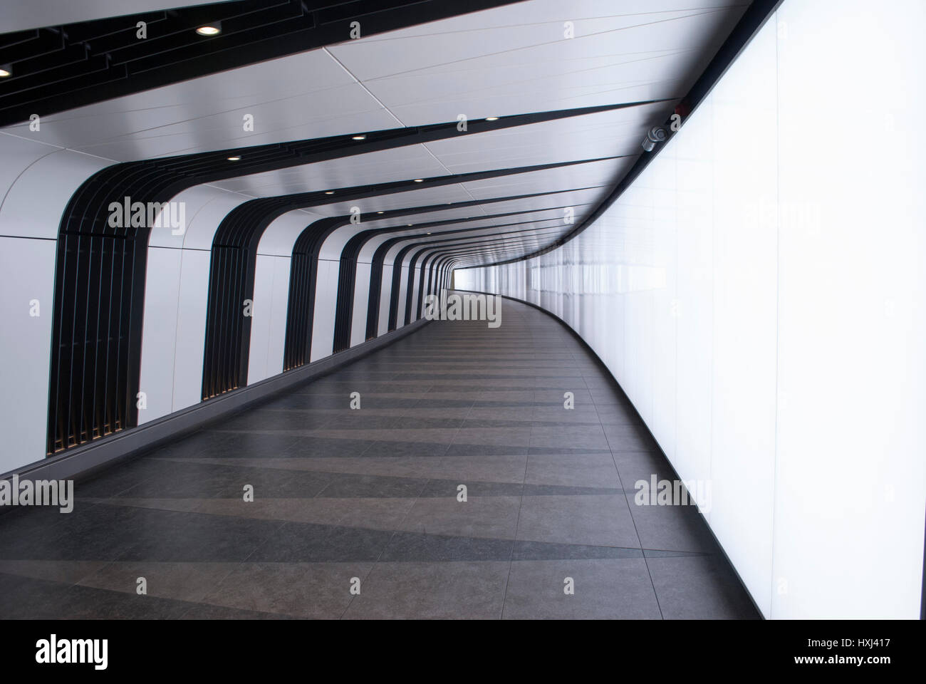 Pedestrian tunnel with integrated light wall in King's Cross Station, designed by Allies & Morrison Stock Photo