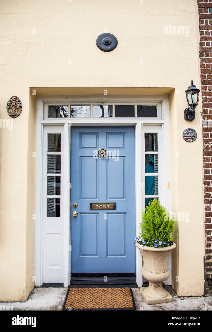 Vintage light blue colour house front door door with a door knocker and letter slot, Charleston, South Carolina, USA, US historic district shrubs PT Stock Photo