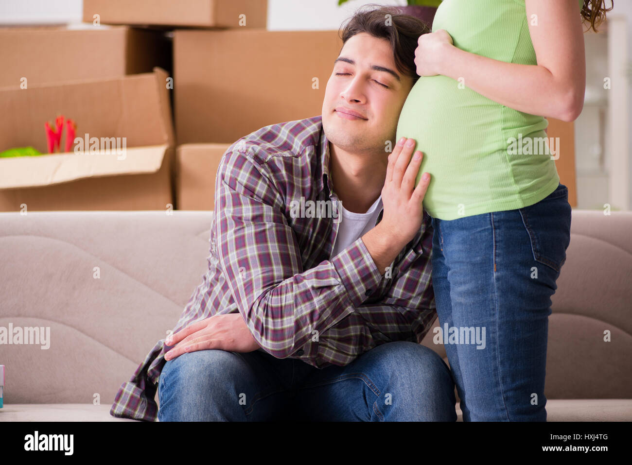 Man Expecting Young couple of man and pregnant wife expecting baby Stock Photo - Alamy