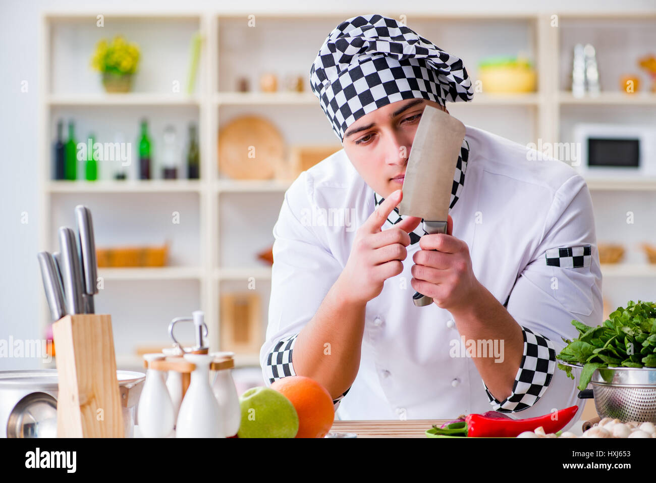 Work About Cook Young male cook working in the kitchen Stock Photo - Alamy