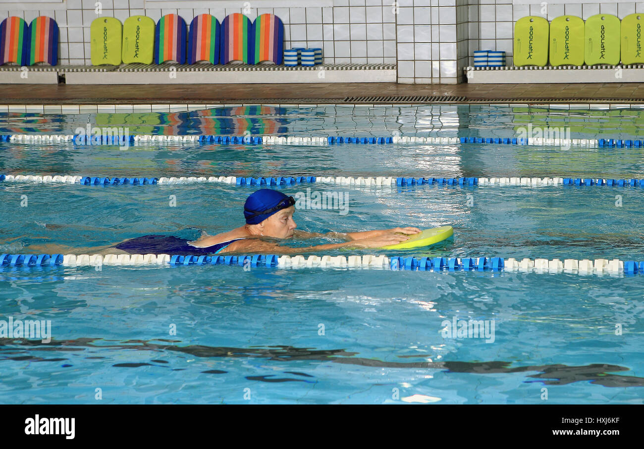 Elderly woman swimming in pool hi-res stock photography and images - Alamy
