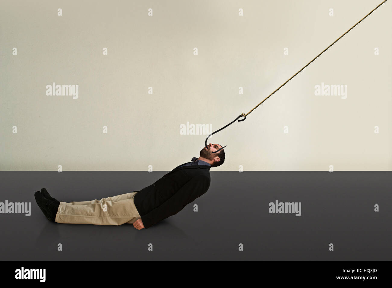 A hooked business man is dragged somewhere Stock Photo Alamy