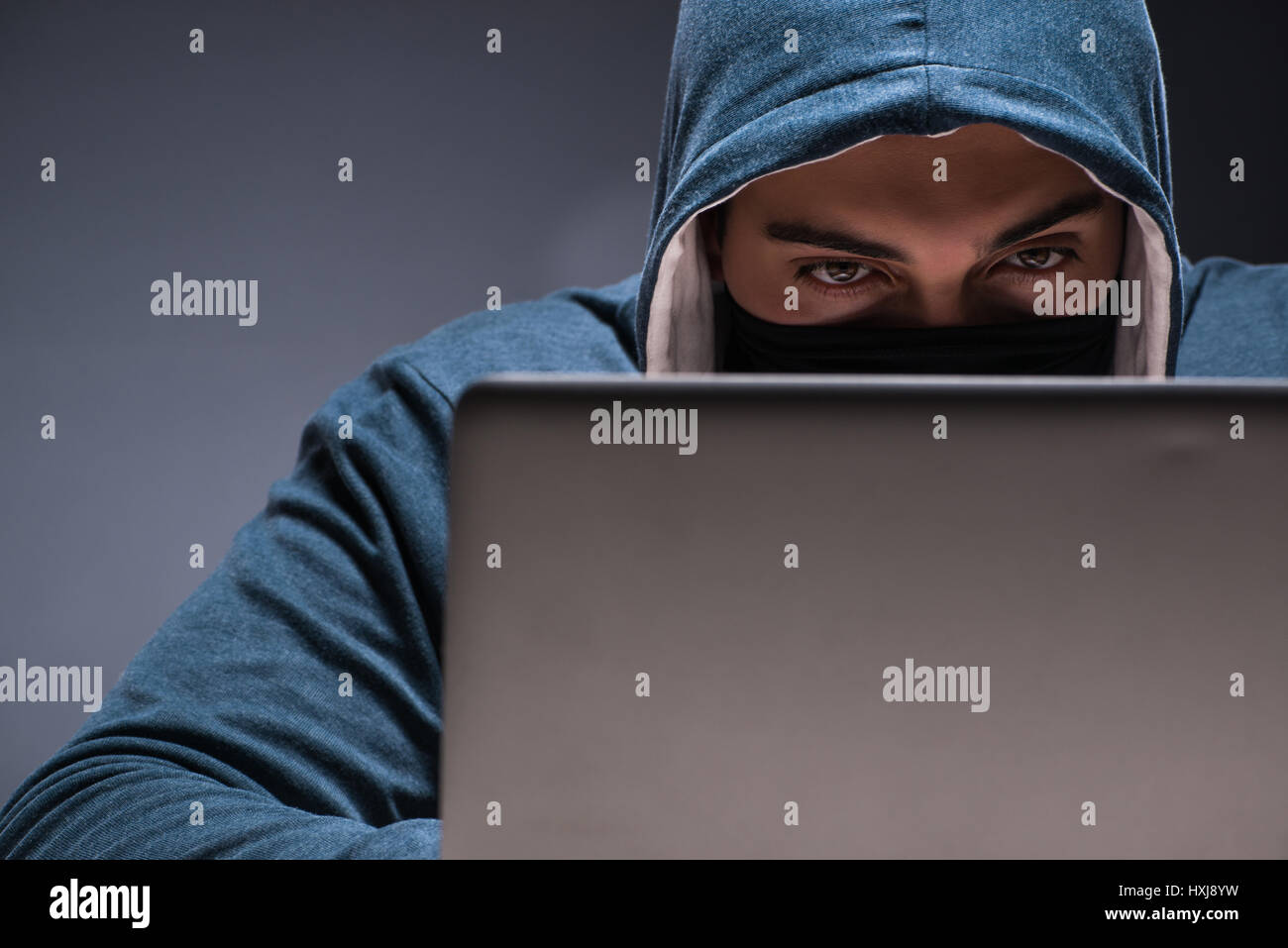Computer hacker working in dark room Stock Photo - Alamy