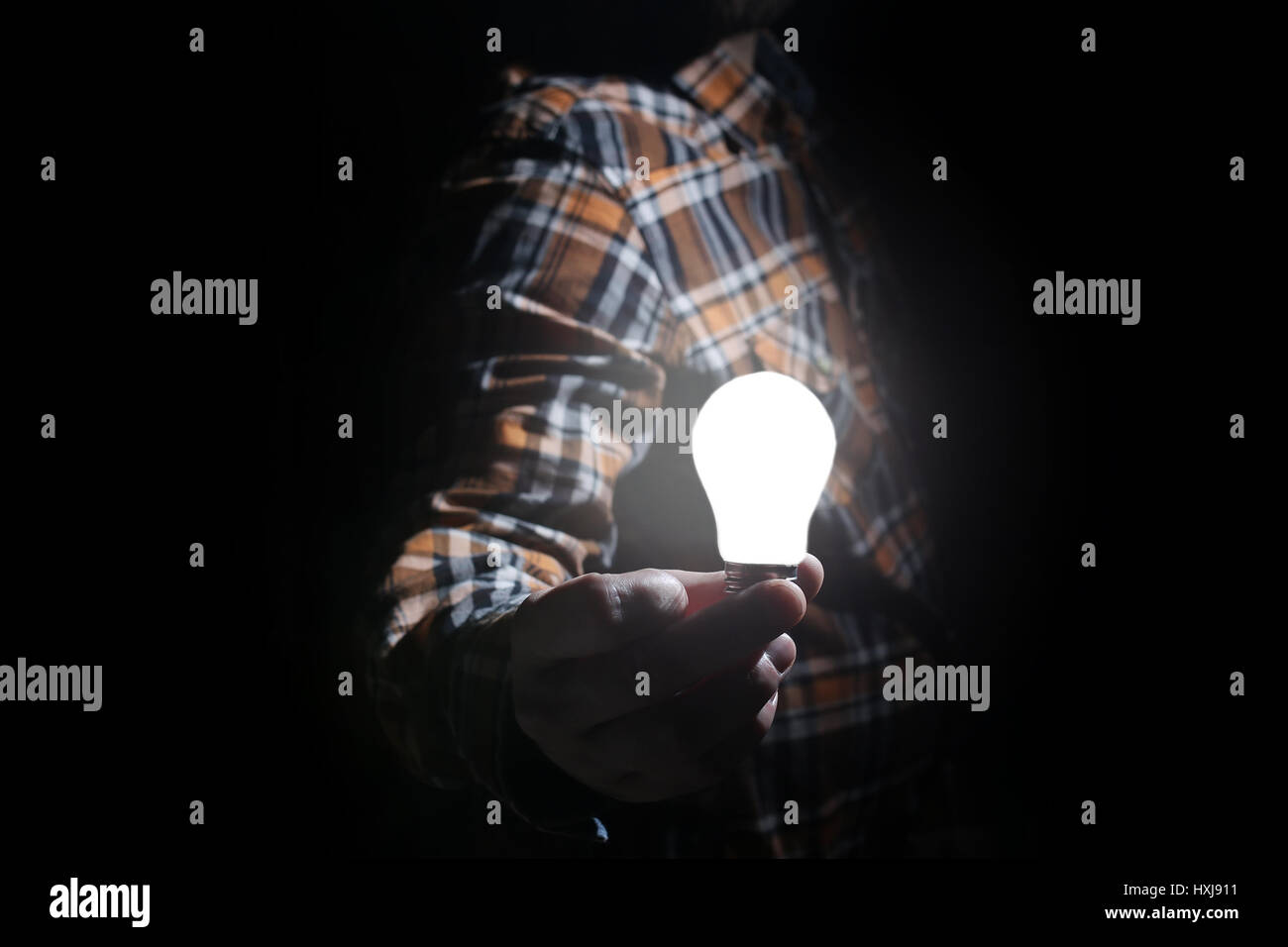 man hold glow lamp in hand Stock Photo - Alamy