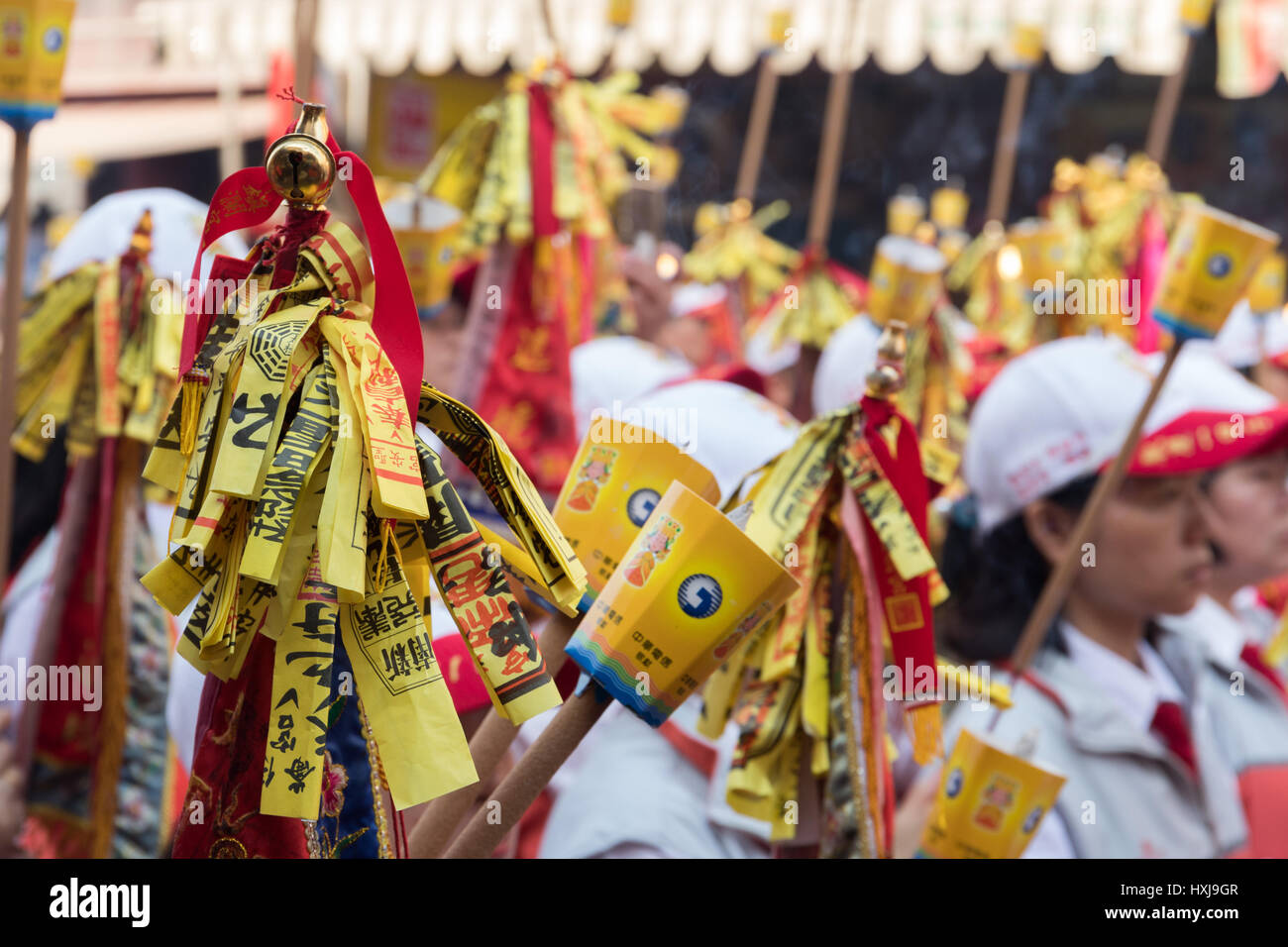 Hsingang, Taiwan. 28th Mar, 2017. Followers of the goddess Matsu, protector of seafarers and fishermen, hold flags with paper talismans collected at the temples they pass during the nine-day Matsu pilgrimage as they attend the Matsu blessing ceremony at Fengtian Temple in Hsingang in southern Taiwan on March 28. According to the organizers, the Matsu pilgrimage is one of the world's biggest religious festivals and attracts about 1 million participants over the nine days every year. Credit: Perry Svensson/Alamy News Stock Photo