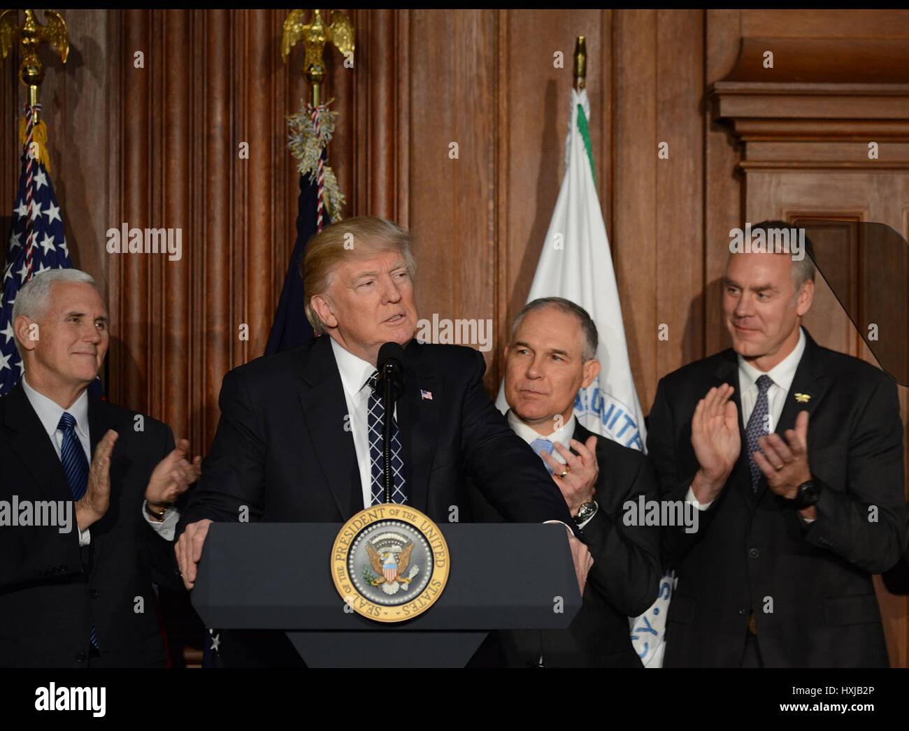 U.S. President Donald Trump smiles after signing the Energy Independence Executive Order at the Department of the Interior March 28, 2017 in Washington, DC. The order rolls back most of President Barack Obama's climate-change rules and environmental policies including the landmark Clean Power Plan. Stock Photo